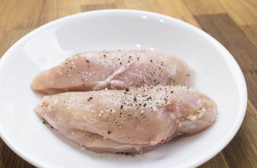Season chicken breasts with kosher salt and ground black pepper.
