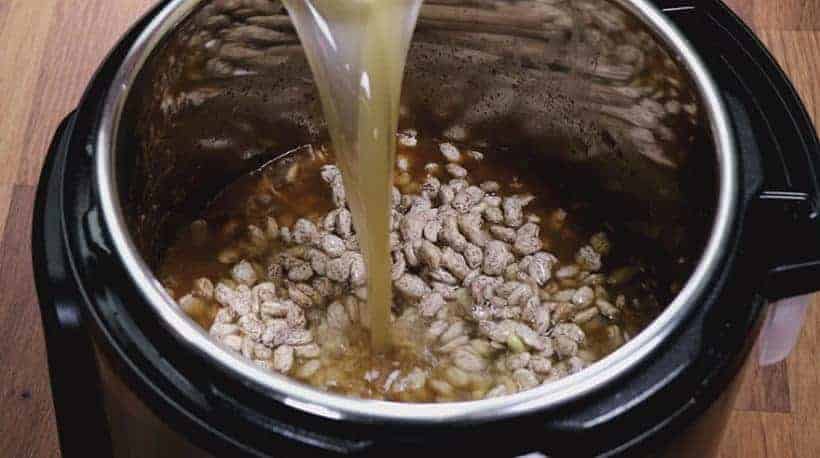 Instant Pot Refried Beans Recipe: add unsalted chicken stock and pinto beans in Instant Pot #instantpot